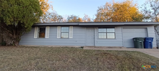 view of side of property featuring a lawn and a garage