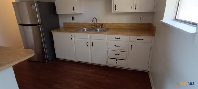 kitchen featuring white cabinets, stainless steel fridge, dark wood-type flooring, and sink