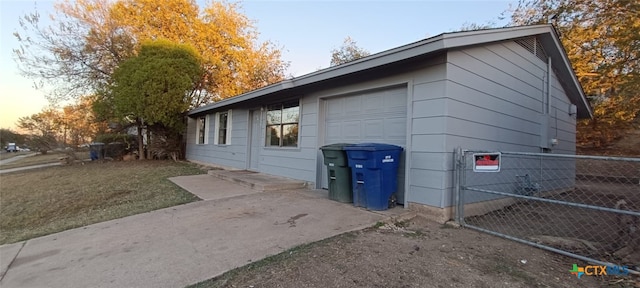 property exterior at dusk featuring a garage