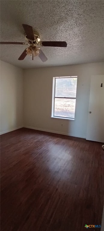 unfurnished room with a textured ceiling, ceiling fan, and dark hardwood / wood-style floors