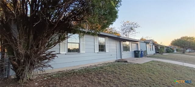 property exterior at dusk with a yard