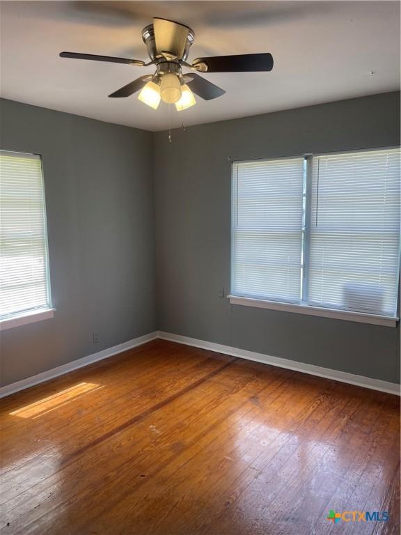 704 E 2nd St, Victoria, TX 77901 - spare room with wood-type flooring and ceiling fan