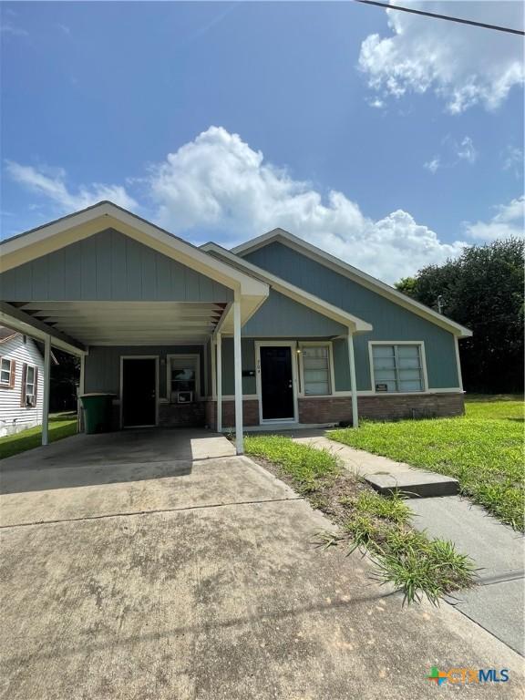 704 E 2nd St, Victoria, TX 77901 - view of front of home with concrete driveway and an attached carport