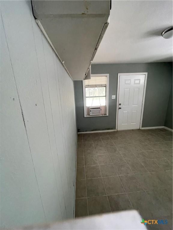 704 E 2nd St, Victoria, TX 77901 - foyer entrance with dark tile patterned floors and cooling unit
