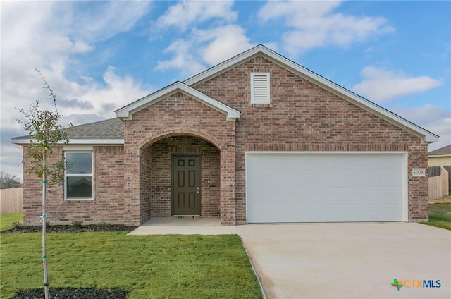 view of front property with a garage and a front yard