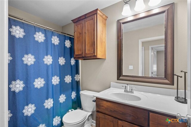 203 Terravista Trl, Victoria, TX 77904 - bathroom featuring vanity, toilet, and a shower with shower curtain