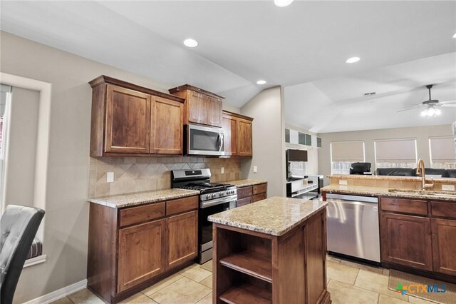 203 Terravista Trl, Victoria, TX 77904 - kitchen featuring appliances with stainless steel finishes, a sink, backsplash, open floor plan, and open shelves