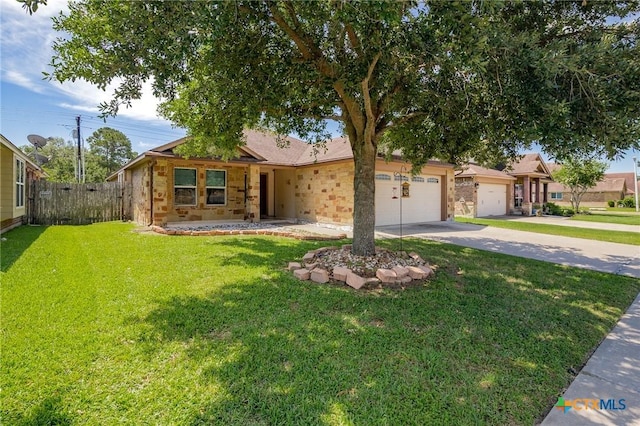 203 Terravista Trl, Victoria, TX 77904 - view of front of house with concrete driveway, an attached garage, and stone siding