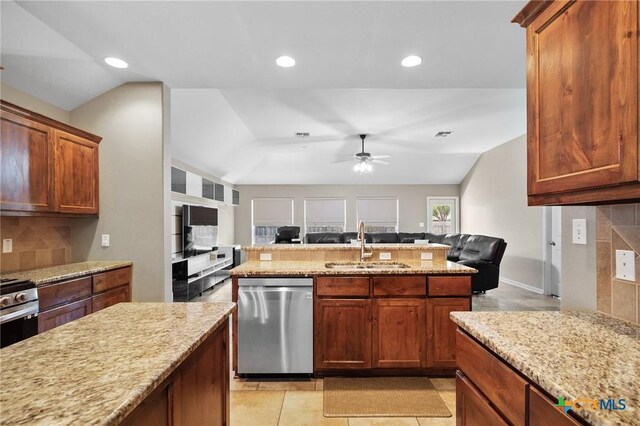 203 Terravista Trl, Victoria, TX 77904 - kitchen featuring appliances with stainless steel finishes, open floor plan, a sink, vaulted ceiling, and tasteful backsplash