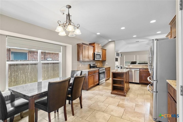 203 Terravista Trl, Victoria, TX 77904 - kitchen featuring appliances with stainless steel finishes, open shelves, backsplash, a chandelier, and a center island