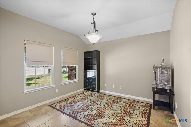 203 Terravista Trl, Victoria, TX 77904 - unfurnished dining area featuring baseboards, tile patterned floors, and vaulted ceiling