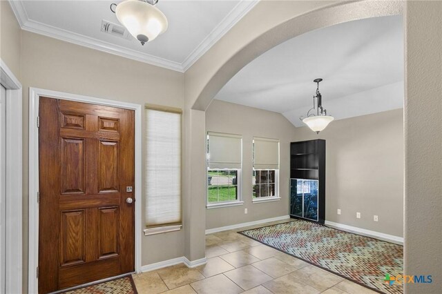 203 Terravista Trl, Victoria, TX 77904 - foyer entrance with arched walkways, light tile patterned floors, baseboards, and ornamental molding