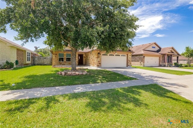 203 Terravista Trl, Victoria, TX 77904 - view of front of home featuring an attached garage, driveway, and brick siding