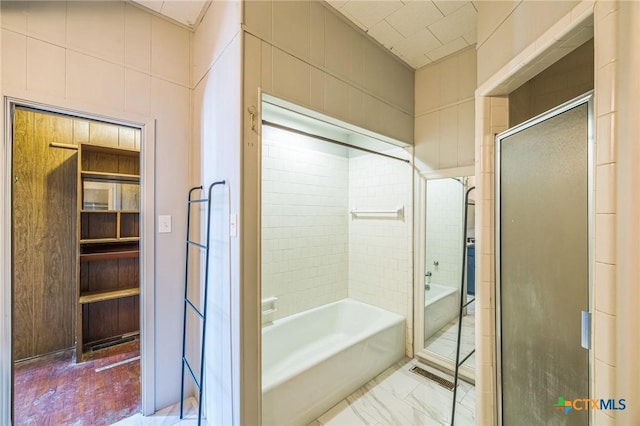bathroom with a shower stall and a bath