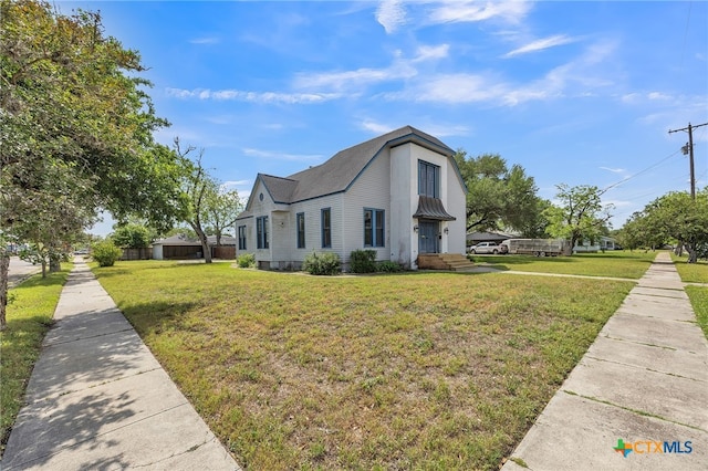 view of side of home featuring a yard