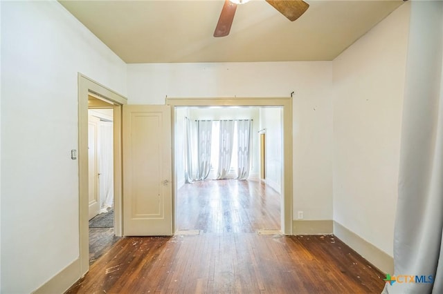 unfurnished room with ceiling fan and wood-type flooring