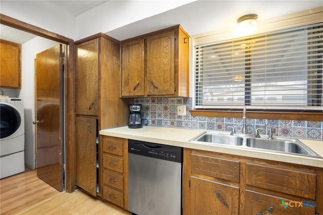 kitchen featuring light wood-style floors, brown cabinets, stainless steel dishwasher, and light countertops