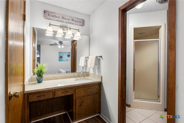 bathroom featuring a textured ceiling, a shower stall, vanity, and connected bathroom