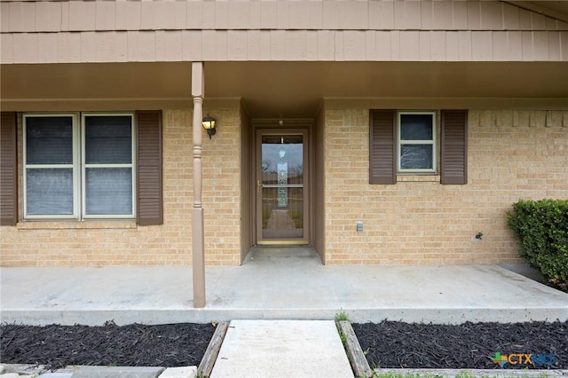 property entrance with brick siding