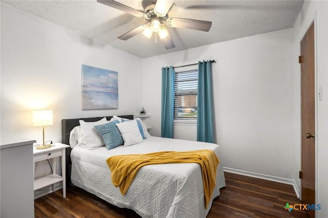 bedroom featuring ceiling fan, a textured ceiling, baseboards, and wood finished floors