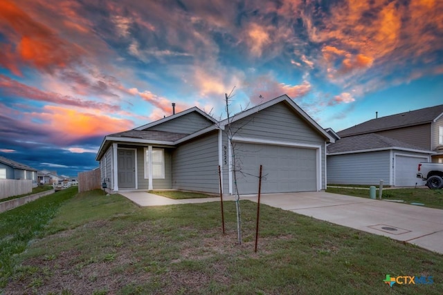 view of front of house featuring driveway, a garage, a front lawn, and fence