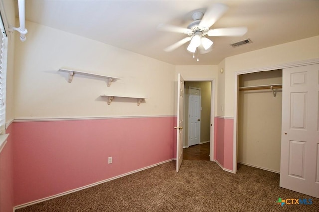 unfurnished bedroom with carpet, visible vents, a closet, and ceiling fan