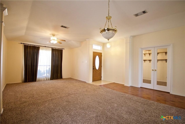 foyer with a ceiling fan, french doors, visible vents, and carpet floors