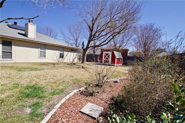 view of yard with an outbuilding, a shed, and a fenced backyard