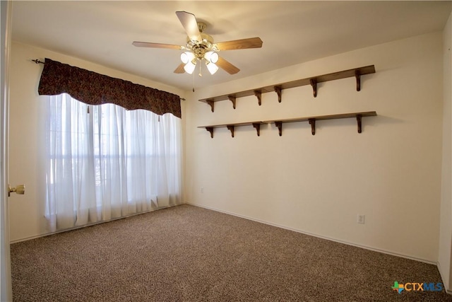 spare room with carpet and ceiling fan