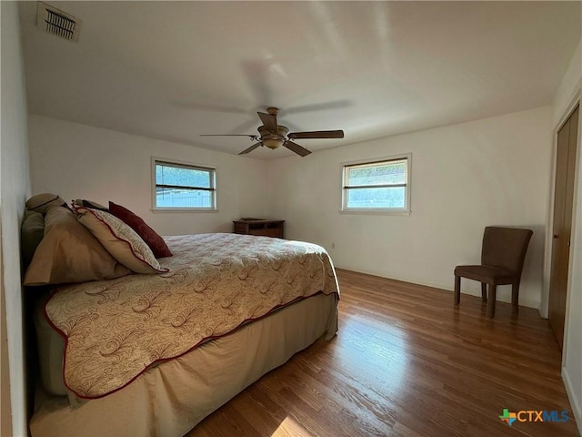 105 Brentwood Pl, Port Lavaca, TX 77979 - bedroom with multiple windows, wood finished floors, and ceiling fan