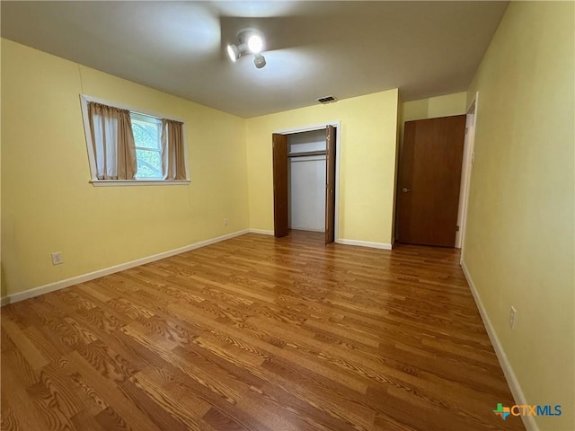 105 Brentwood Pl, Port Lavaca, TX 77979 - unfurnished bedroom with wood finished floors and baseboards