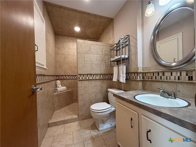 105 Brentwood Pl, Port Lavaca, TX 77979 - bathroom featuring walk in shower, vanity, tile patterned floors, and tile walls