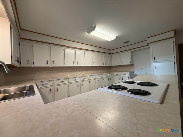 105 Brentwood Pl, Port Lavaca, TX 77979 - kitchen with white electric cooktop, light countertops, and white cabinets