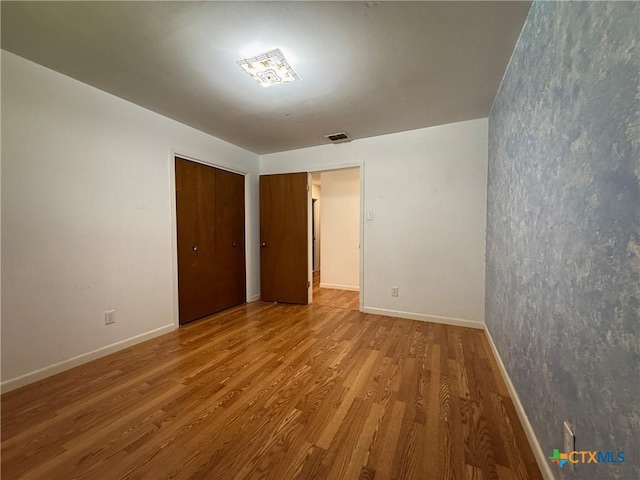 105 Brentwood Pl, Port Lavaca, TX 77979 - unfurnished bedroom with wood finished floors and a closet