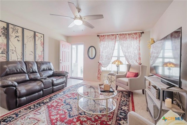 carpeted living room featuring ceiling fan