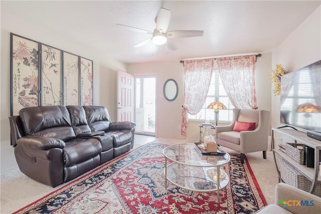 living room with light colored carpet and ceiling fan