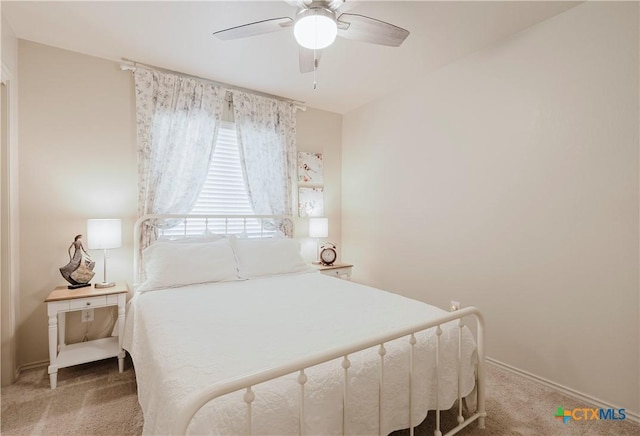 bedroom with ceiling fan and light carpet