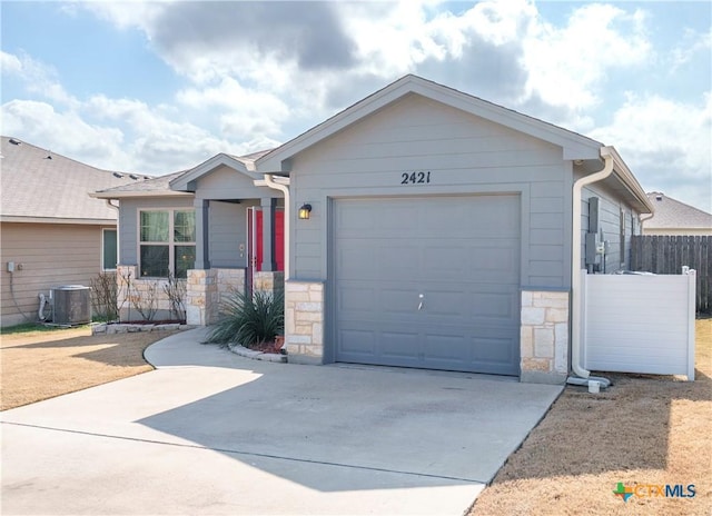 ranch-style house with cooling unit and a garage