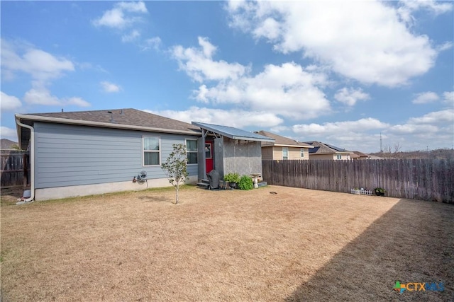 rear view of property with a lawn