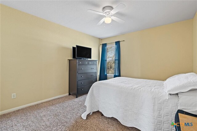 bedroom featuring baseboards, a ceiling fan, and carpet flooring