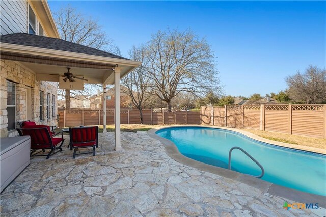 view of pool featuring a fenced backyard, a fenced in pool, a ceiling fan, and a patio