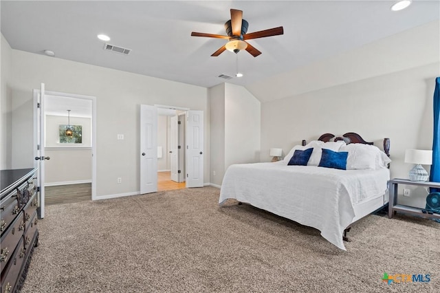 carpeted bedroom with visible vents, recessed lighting, lofted ceiling, and baseboards