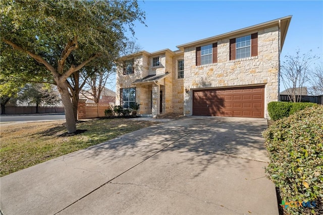 view of front facade with a garage, stone siding, and concrete driveway