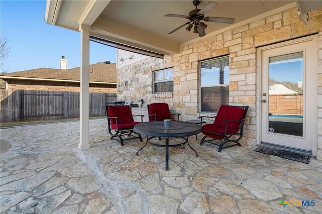 view of patio / terrace featuring a ceiling fan and fence