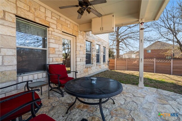 view of patio / terrace featuring fence and ceiling fan