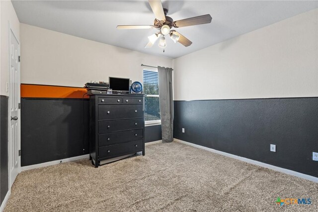 carpeted bedroom featuring baseboards and ceiling fan