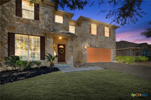 view of front facade featuring aphalt driveway, a garage, stone siding, and a front lawn