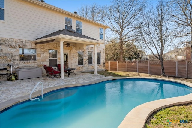 view of pool with a fenced in pool, a patio area, fence, and ceiling fan