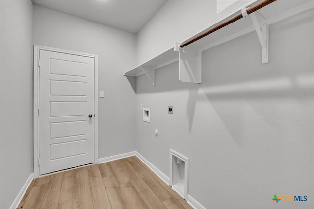 washroom with light hardwood / wood-style floors, hookup for a gas dryer, hookup for a washing machine, and electric dryer hookup