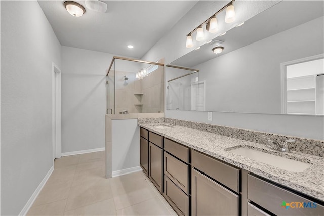 bathroom featuring tile patterned flooring, vanity, and a shower with shower door